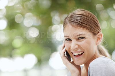 Buy stock photo Portrait of an attractive young woman speaking on her cellphone