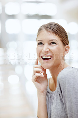 Buy stock photo An attractive young woman smiling happily and touching her face