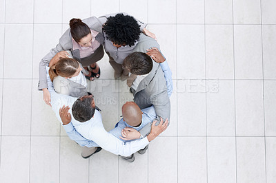 Buy stock photo Top view of a business team in a huddle as they discuss a strategy - Copyspace