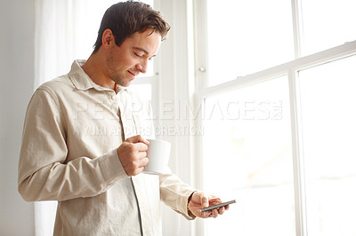 Buy stock photo Morning, text and coffee with phone, social media and email check in home by window. Hot drink, mobile and online communication with smile and happy remote worker with internet search and scroll