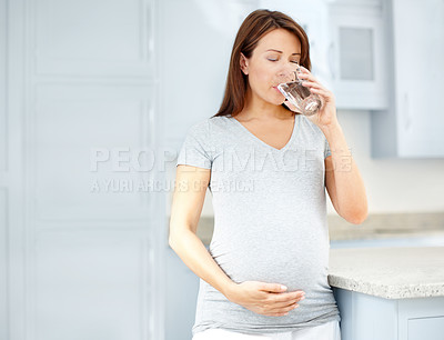 Buy stock photo Pregnant woman, morning and drinking water in home, nutrition and aqua for hydration in kitchen. Female person, maternity detox and mineral liquid for energy or thirst, refreshing beverage and glass