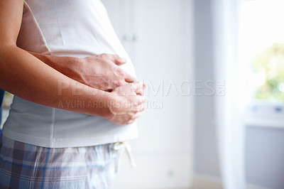 Buy stock photo Cropped image of a loving husband holding his wife's baby bump - Copyspace