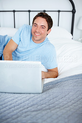 Buy stock photo Man, laptop and portrait on bed with internet, streaming movie and online subscription to entertainment. Male person, morning and comfortable in home with social media, website and relax in bedroom