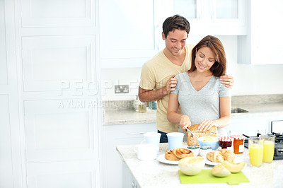 Buy stock photo Pregnant woman, man and happy with cooking in kitchen, hug and bread for breakfast, diet or nutrition. People, couple and meal prep for pregnancy, smile and prenatal health in morning at family home