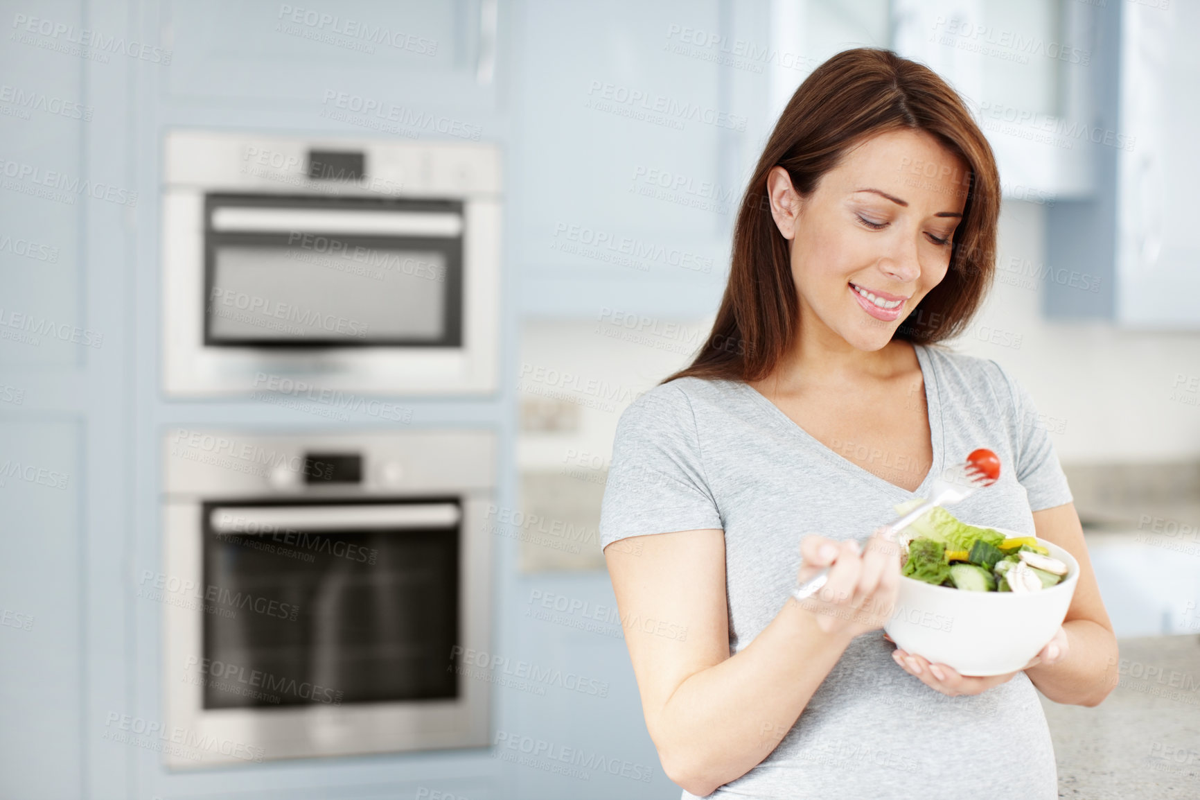 Buy stock photo Happy, pregnant woman and eating salad in house with smile, healthy breakfast and minerals for vitamins. Morning, hungry and mother to be with organic food for wellness, benefits and diet nutrition