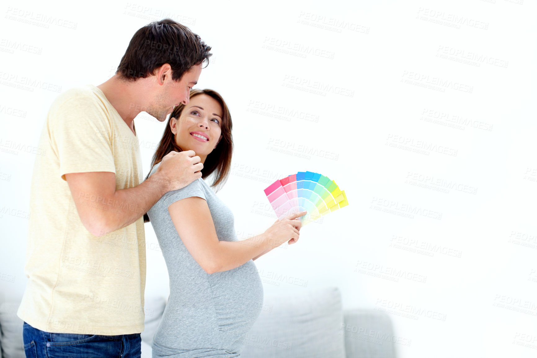 Buy stock photo Pregnancy, happy couple and color option in home for decorating room, maternity leave or choice. Smile, planning or people hug with support for motherhood, love or decision for future renovations