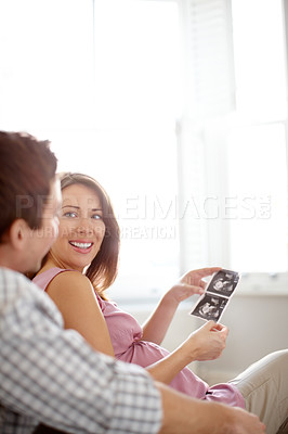 Buy stock photo Couple, home and baby ultrasound with love, family and parent care with announcement. Happy, smile and healthy sonogram with results, wellness and growth progress of pregnant woman with mockup