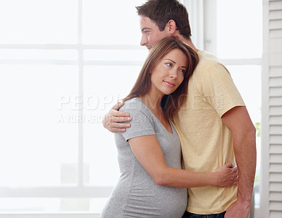 Buy stock photo Thinking, couple and hug in home for pregnancy, maternity leave or responsibility in house with peace. Ideas, relax or calm people with trust or support for motherhood, love or healthy relationship