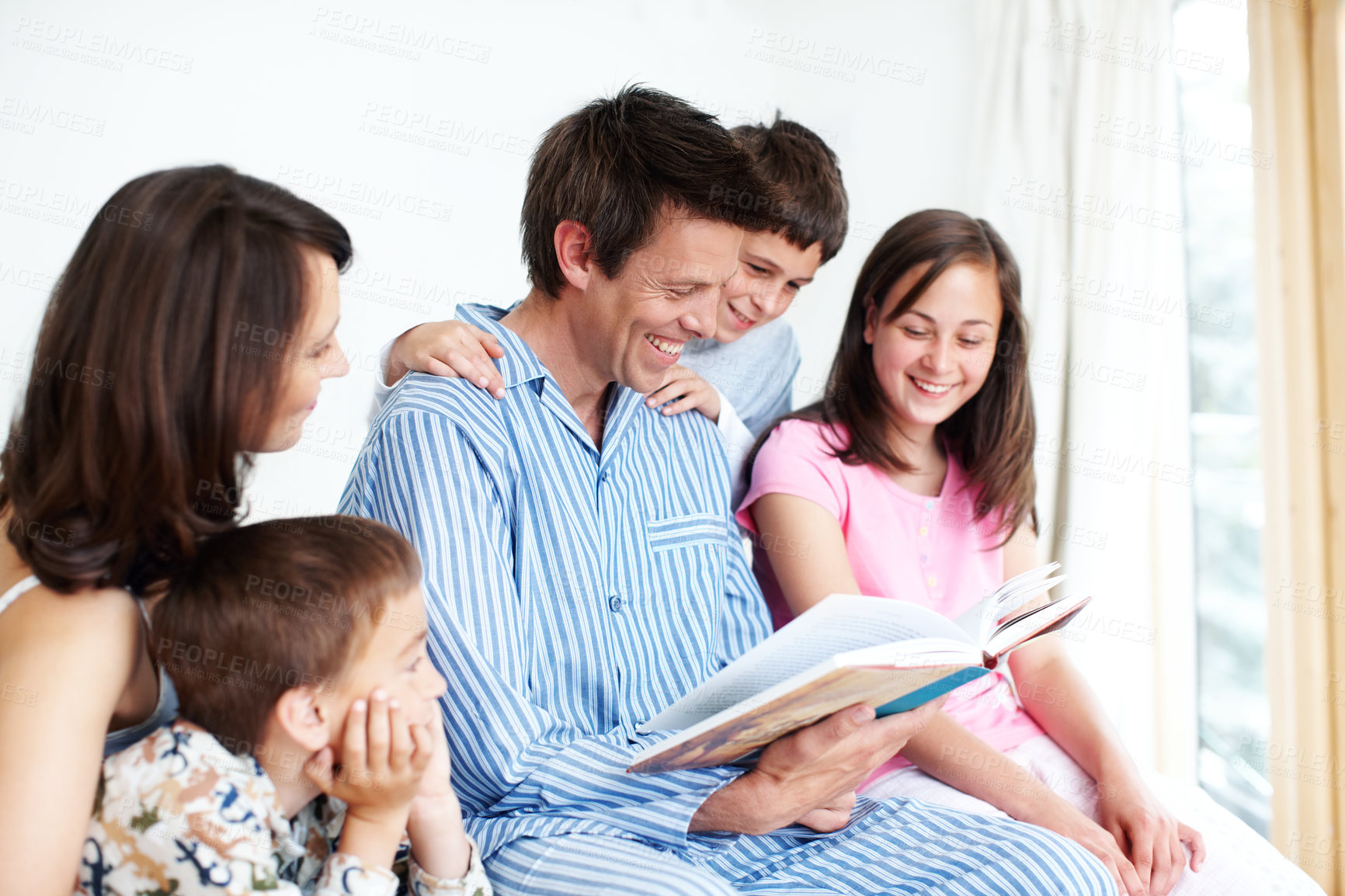 Buy stock photo Happy family, kids and parents reading book, learning story or siblings bonding together in home. Children, mother and father storytelling in bedroom for morning education, fantasy fairytale or relax