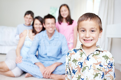 Buy stock photo Bedroom, pajamas and portrait of happy boy with family blur in home for support, love or wellness. Weekend, mother or dad with toddler, children or growth for bonding together with parents in morning