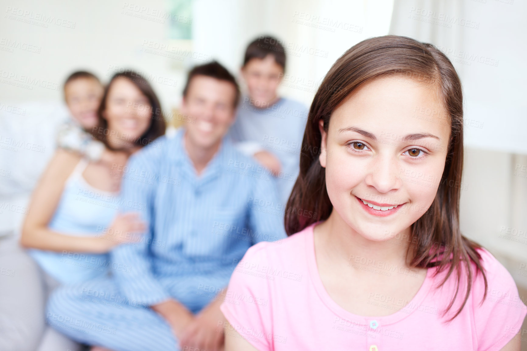 Buy stock photo Bedroom, morning or portrait of happy girl with family blur in home for support, love or wellness. Teenager, mom or dad with toddler, children or growth for bonding together with parents or siblings