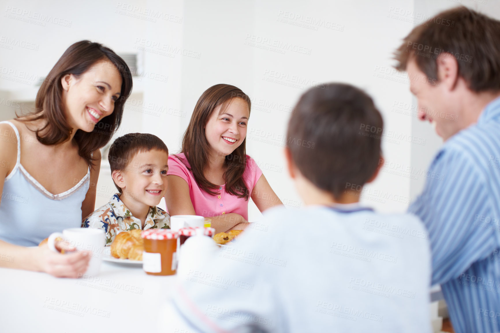 Buy stock photo Family, trust and morning breakfast in home, dining table and support with eating healthy food. Parents, children and talking together in kitchen with meal, love and brunch nutrition for bonding