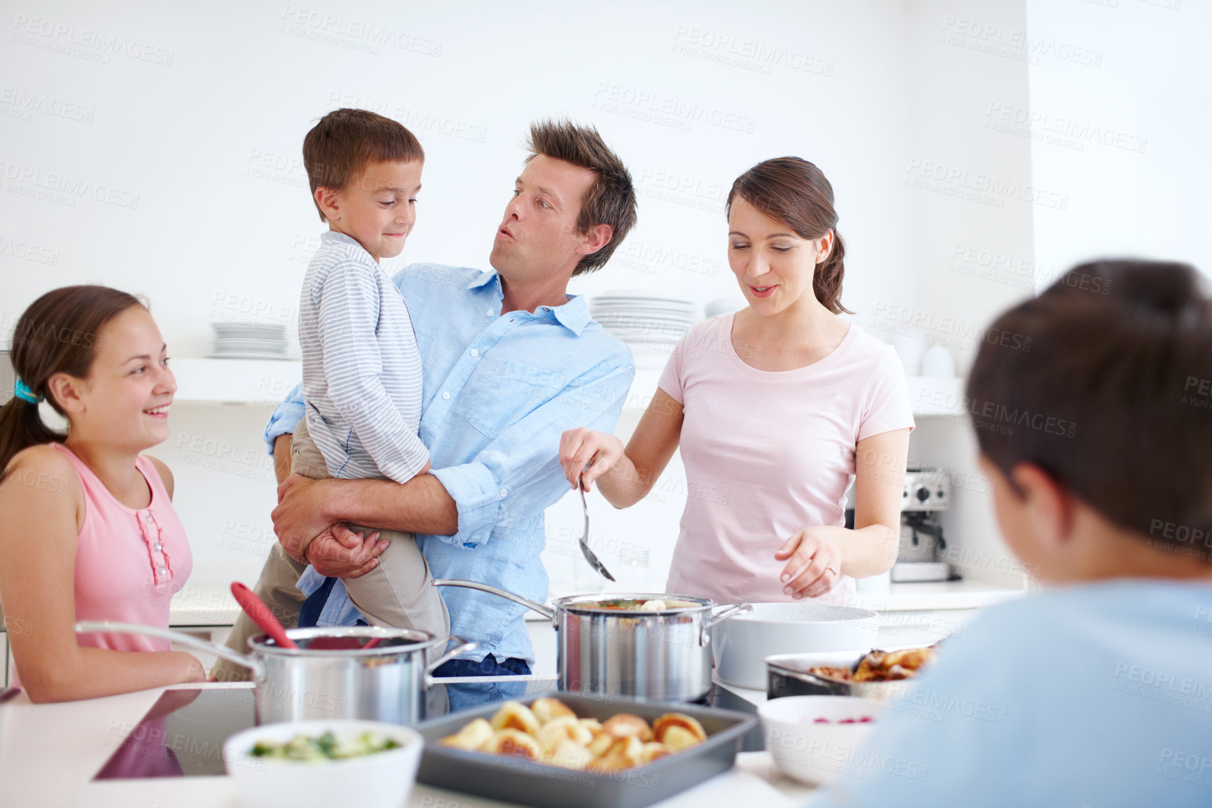 Buy stock photo Family, happy and cooking in kitchen with love, Thanksgiving celebration and support. Parents, children and excited in home for meal preparation, nutritional lunch and smile in apartment for learning