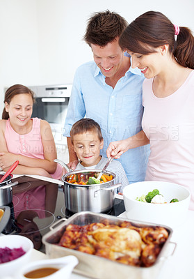 Buy stock photo Family, smile and cooking in kitchen with love, Thanksgiving celebration or support. Parents, children and happy in home for vegetable preparation, nutritional lunch and excited at stove for learning