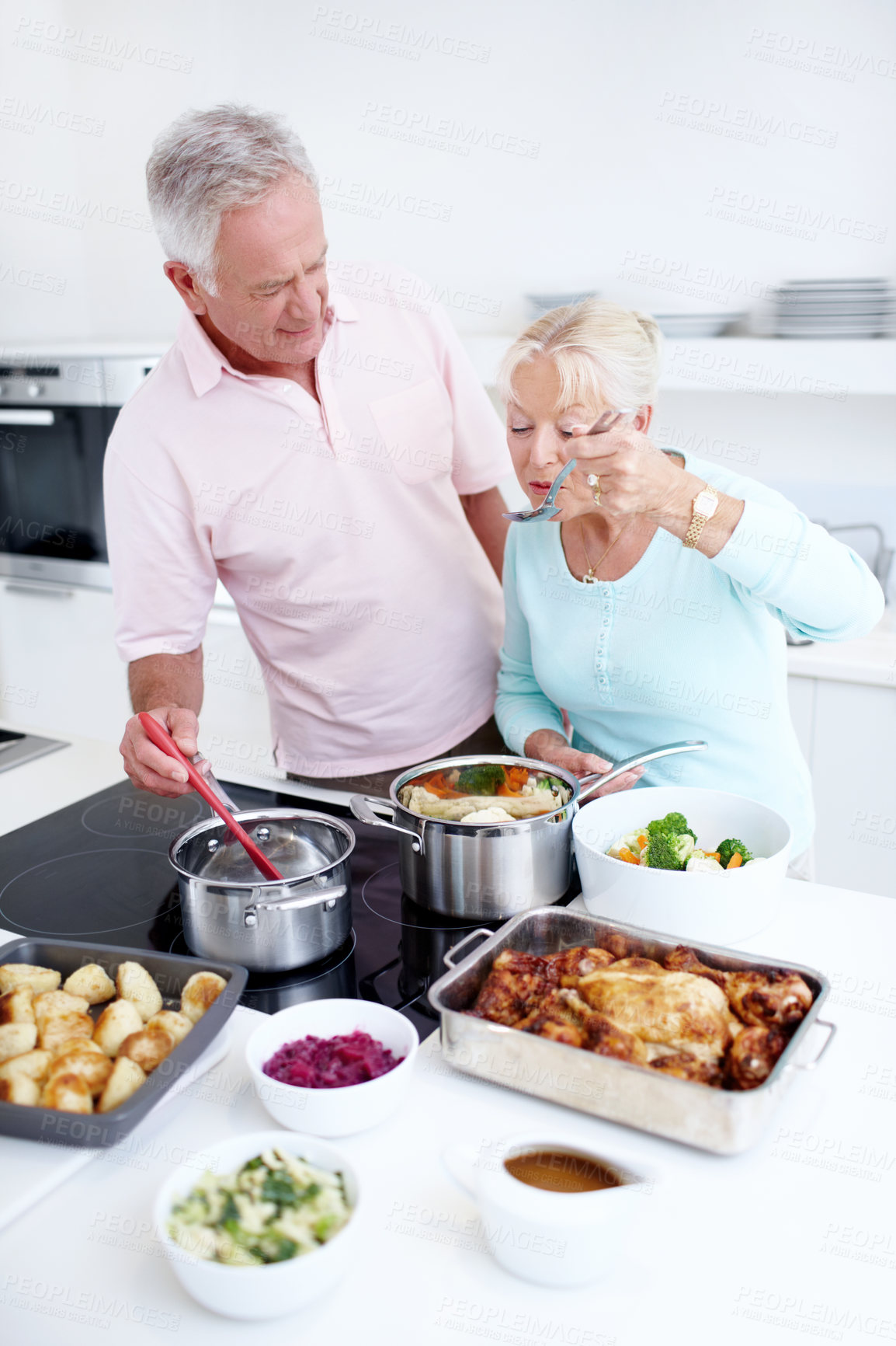 Buy stock photo Senior couple, taste and cooking with food for meal prep, thanksgiving and celebration of gratitude. Happy people, man and woman in kitchen for nutrition, feedback and bonding in marriage at home