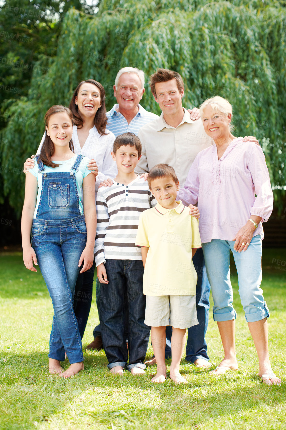 Buy stock photo Happy, portrait or big family with hug in nature for holiday, weekend or bonding together. Grandparents, parents and children or kids with smile or generations for outdoor vacation or support at park