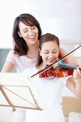 Buy stock photo Mother, violin and helping child in home with music and support for talent show or performance practice. Musician, happy and playing with teaching, love and family care in lounge with instrument