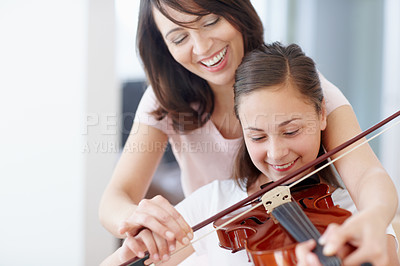 Buy stock photo Mother, violin and support for child in home with music and helping for talent show or performance practice. Musician, happy and playing with teaching, love and family care in lounge with instrument