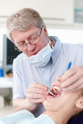 Buy stock photo Portrait of female patient with dentist working on her teeth