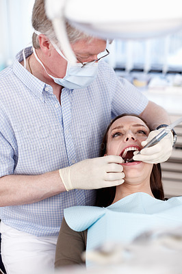 Buy stock photo Man, dentist and patient with tools for consultation, teeth whitening and oral inspection of dental hygiene. Mature, orthodontist and woman of cosmetic procedure, mouth assessment and veneer cleaning