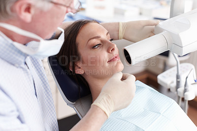Buy stock photo Portrait of female patient going through dental examination in clinic