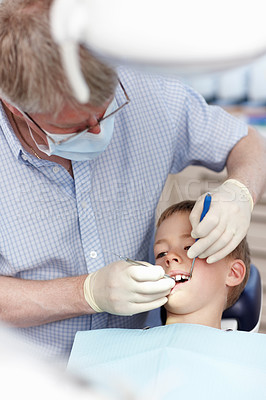 Buy stock photo Portrait of small child going under dental procedure in clinic