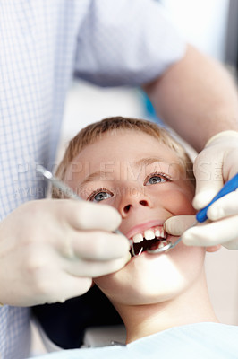 Buy stock photo High angle view of cute boy going under dental treatment in clinic