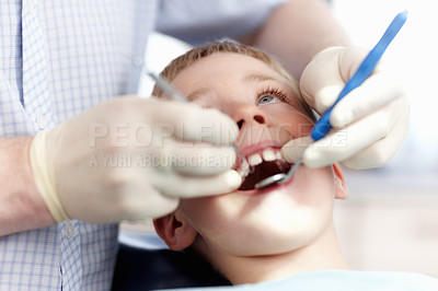 Buy stock photo High angle view of cute boy getting his teeth checked in clinic