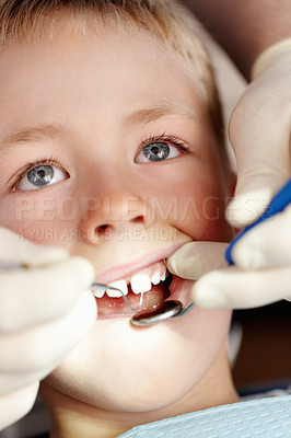 Buy stock photo Closeup of adorable little boy getting his dental treatment done in clinic
