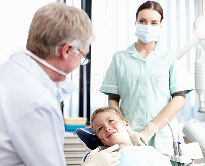 Buy stock photo Portrait of dentist speaking with his young patient in office