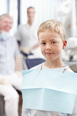 Buy stock photo Portrait of cute young boy smiling with doctors in background