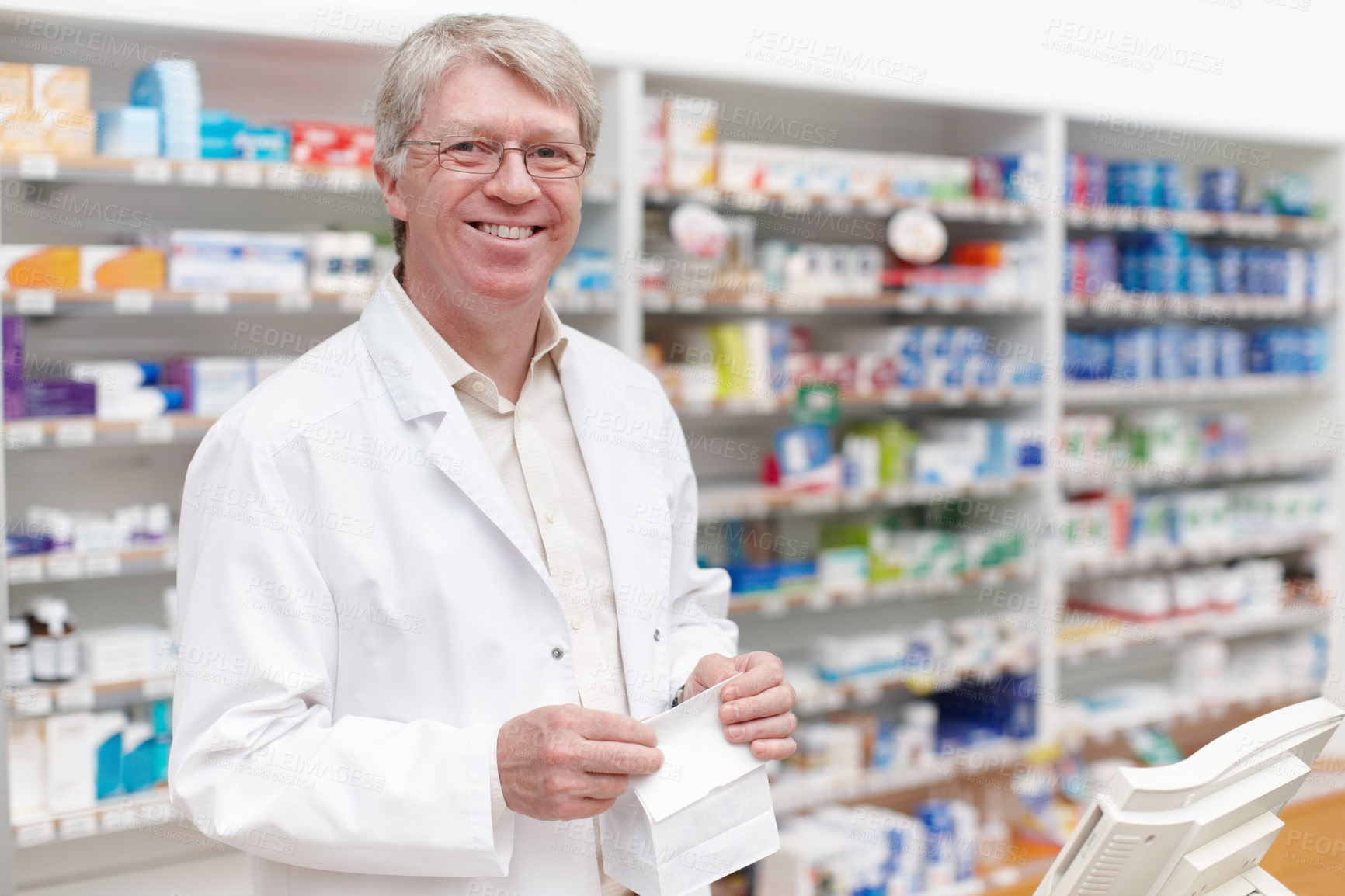 Buy stock photo Man, portrait and pharmacist with medical prescription at dispensary for medication, supplements or pills. Chemist, inventory and mature apothecary with packet for medicine or tablets in drug store