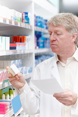 Buy stock photo Man, pharmacy and reading prescription for medication, pills and drug store with box for healthcare. Mature person, shelf and pharmacist with checklist for product, medicine and treatment or stock