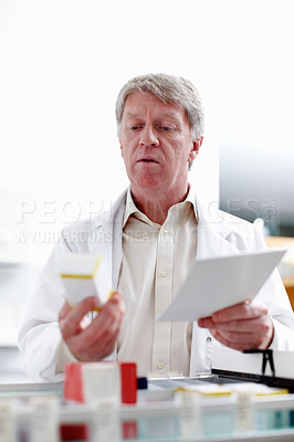 Buy stock photo Pharmacist, inventory and reading for stock, pills or medicine in drugstore, chemist or services. Medical professional, male person and pharmacy as prescription, dispensary or info for advice or care