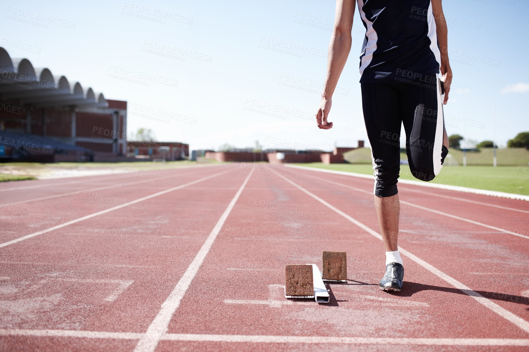 Buy stock photo Man, legs and stretching on running track, warm up and preparation for exercise or workout. Male person, starting block and outdoor for fitness in sportswear, athlete and ready for marathon training