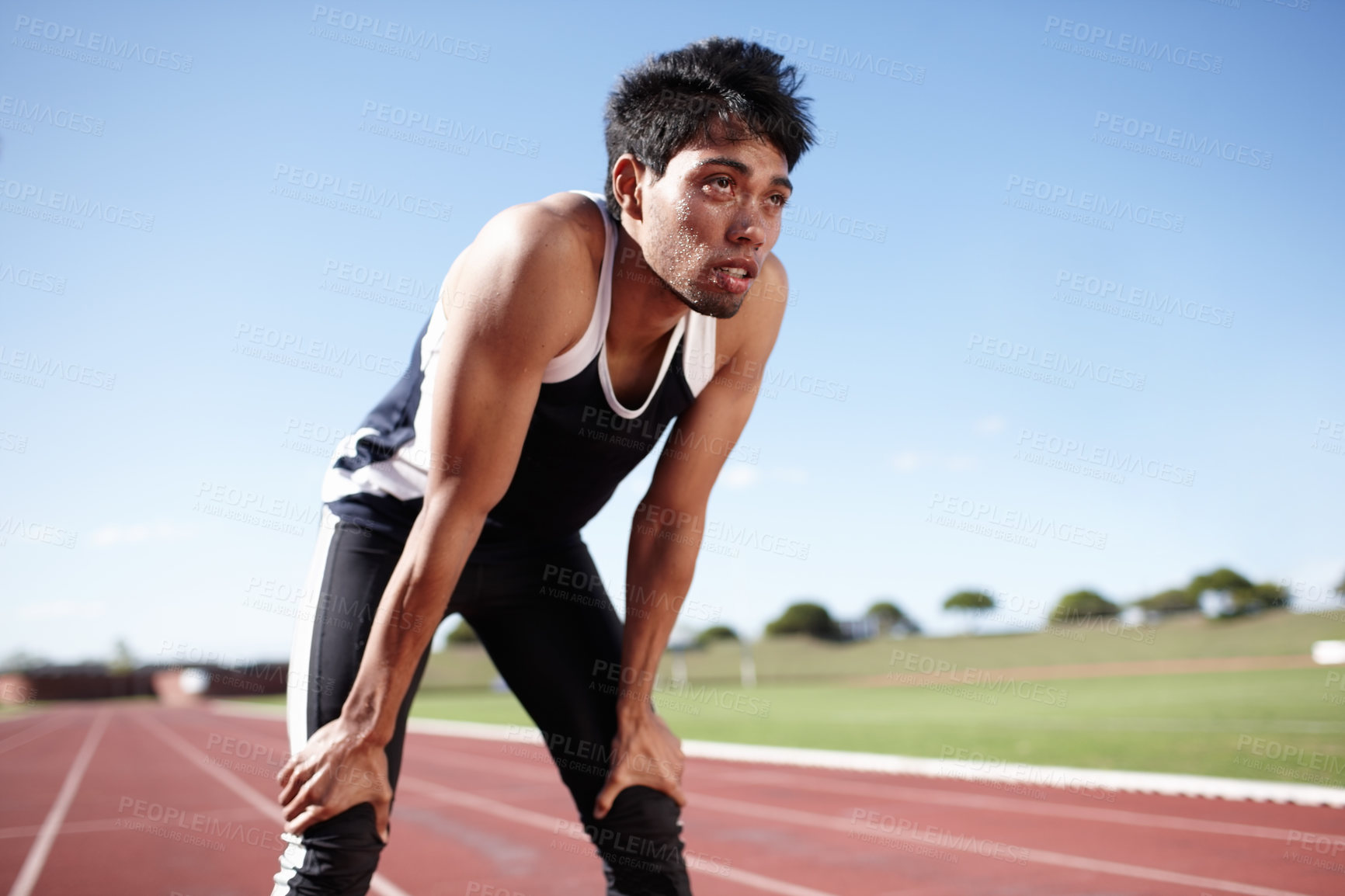 Buy stock photo Thinking, tired runner or man on track for fitness training, workout break or sports exercise. Fatigue, ideas and exhausted athlete in stadium for running development, challenge or race performance