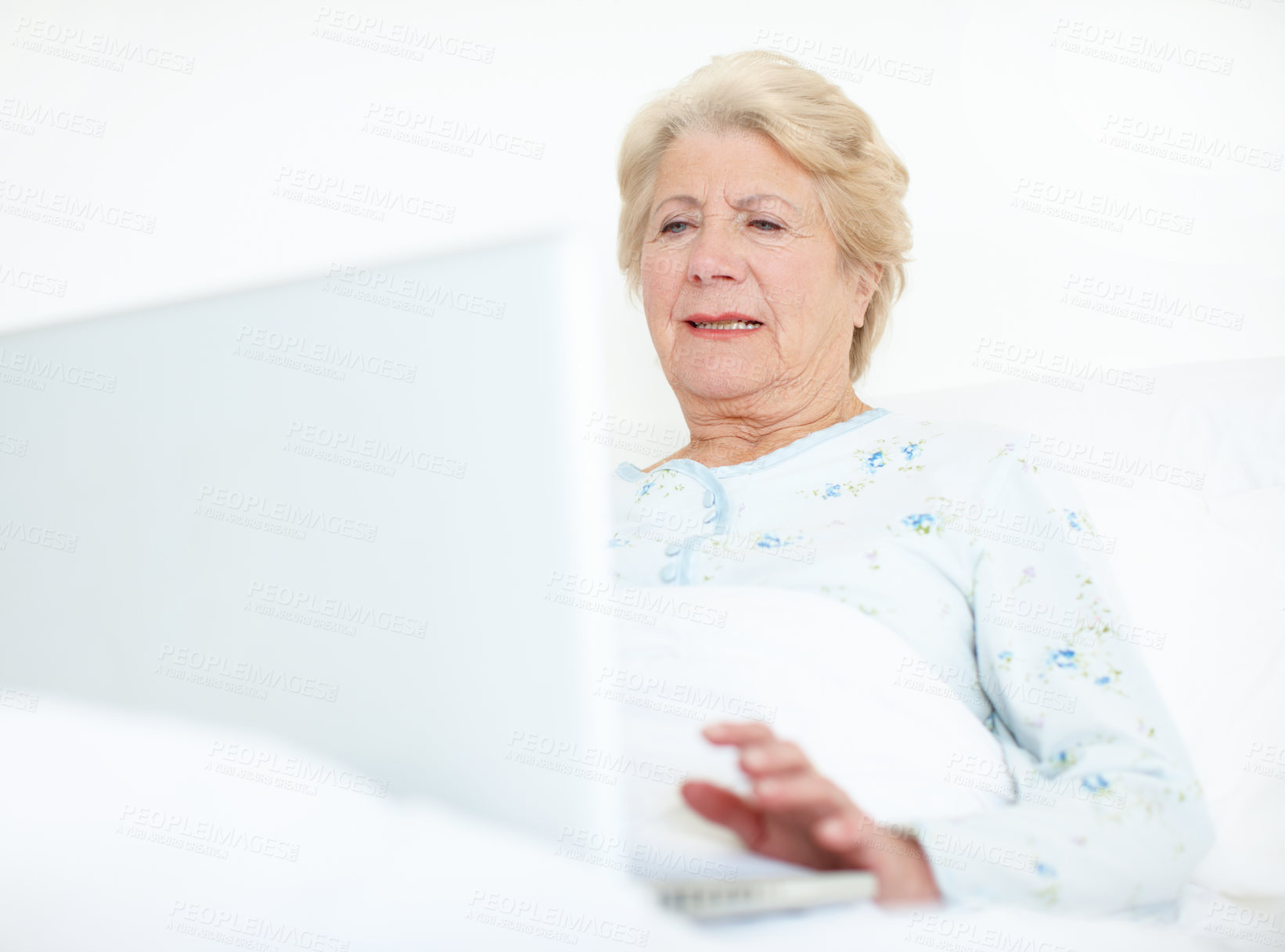 Buy stock photo Elderly female patient browses a laptop from her hospital bed - Copyspace