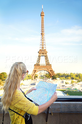 Buy stock photo Rear view of an attractive young woman holding a map while sight seeing in the Paris
