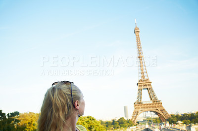 Buy stock photo Rear view of a young woman looking at the Eiffel Tower