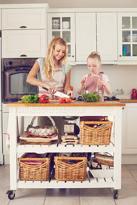 Buy stock photo Mother, girl and vegetables for salad in kitchen with cutting ingredients, meal prep and teaching healthy vegan recipe. Woman, child and learning to cook with support, helping hand or bonding in home