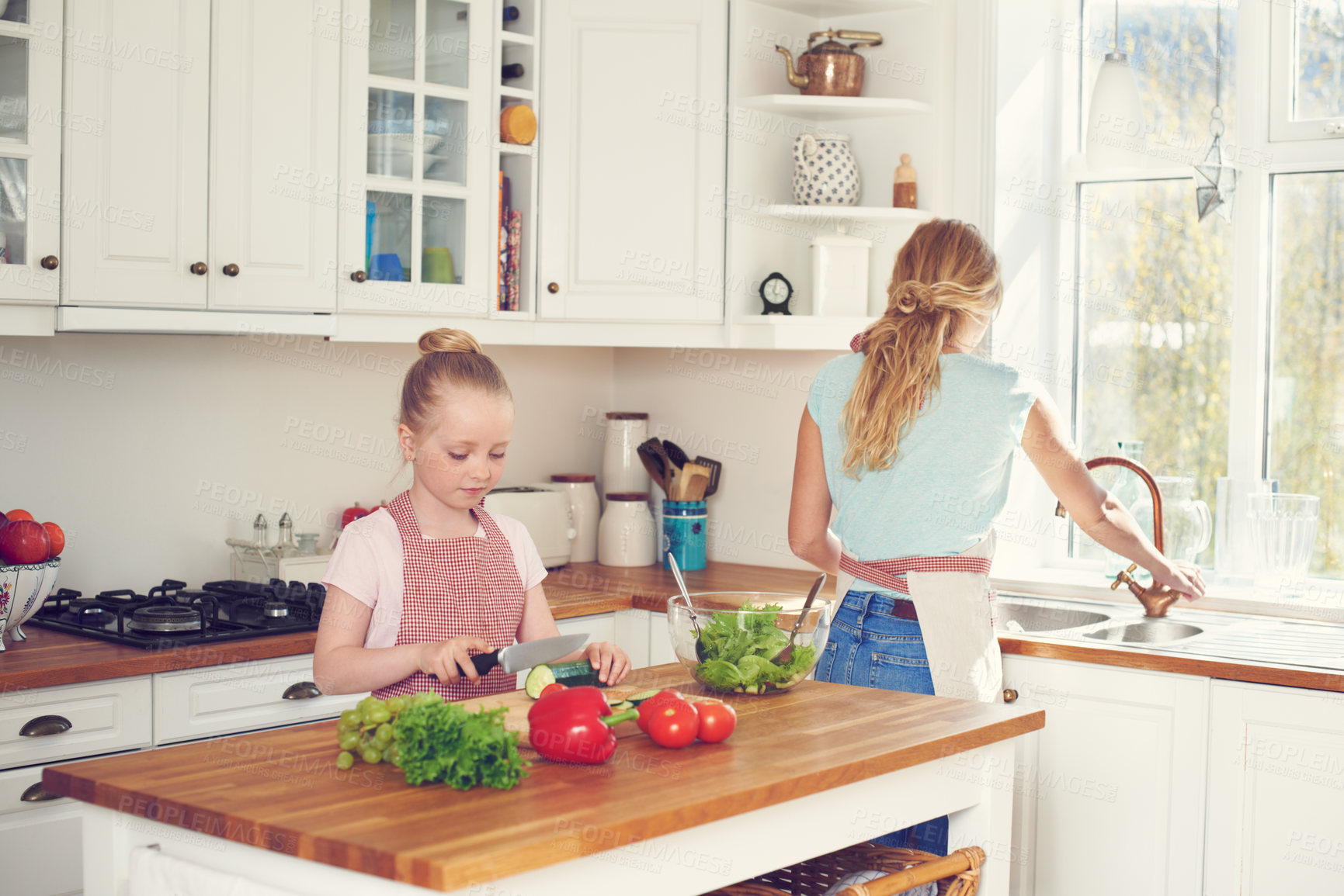 Buy stock photo Mother, child and cutting vegetables for salad in kitchen with ingredients, meal prep and learning healthy vegan recipe. Woman, girl and cooking together for culinary skills and helping hand in home