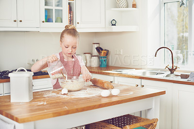 Buy stock photo Baking, ingredients and child in kitchen with bowl for learning to bake cake, dessert and pastry. Food, culinary skills and young girl with dough, recipe and measure milk for sweet treats in home