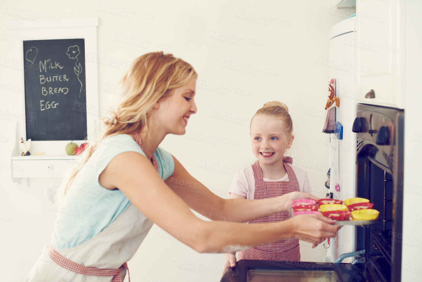 Buy stock photo Kitchen, mother and child with oven for baking, cooking and preparation of cookies for dessert. Happy people, mom and girl with support for cupcake, learning and parent with kid for teaching in home