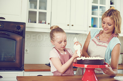 Buy stock photo Frosting, cake and cooking with mother and child in kitchen for baking, ingredients and recipe learning. Bonding, decoration and baker with girl and woman in family home for support, dessert and food