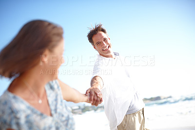 Buy stock photo Beach, holding hands and mature couple with smile, vacation and travel with anniversary. Seaside, relationship and romance with man, happy woman and bonding together with weekend break, ocean or love