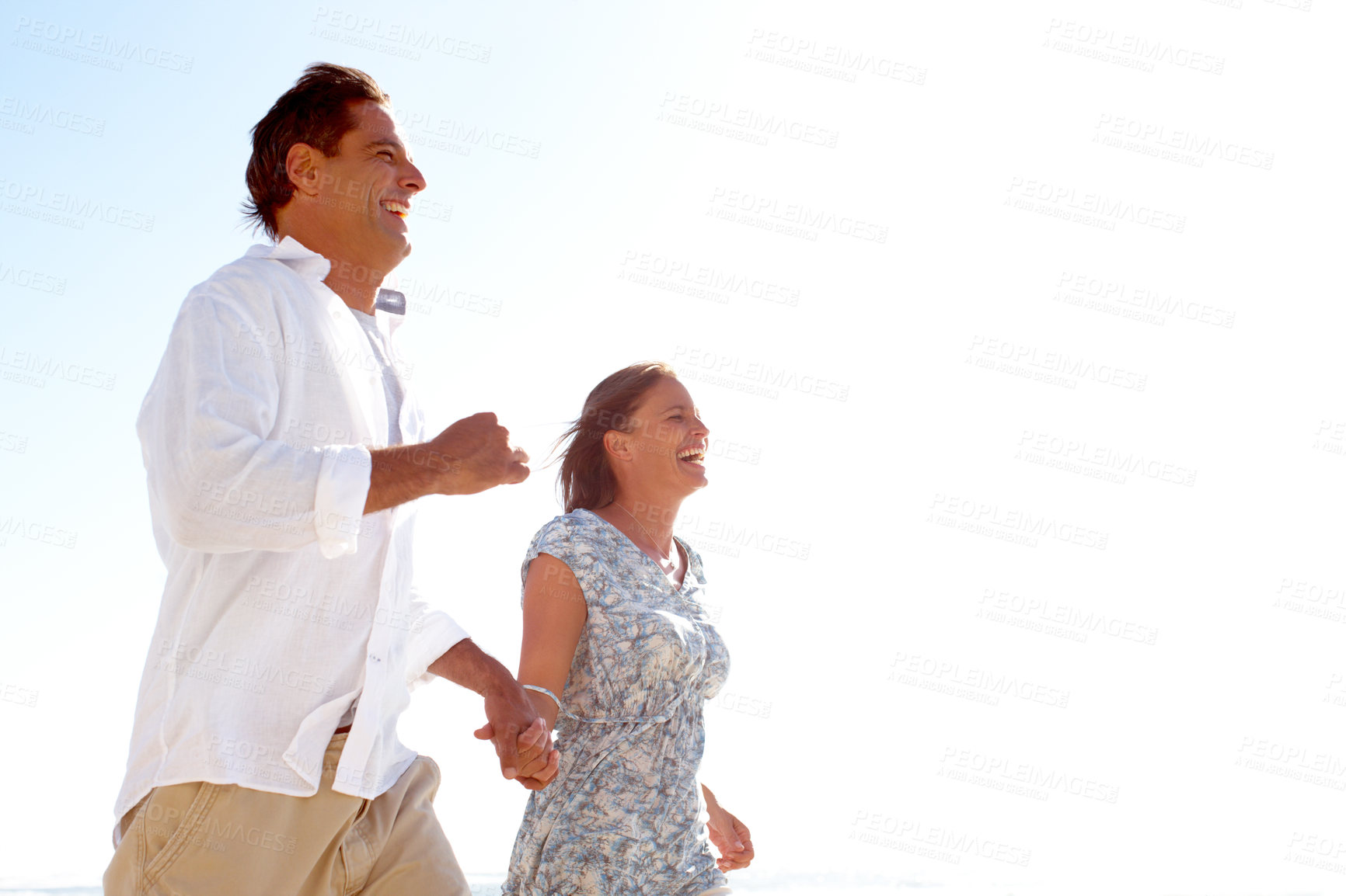 Buy stock photo Beach, couple and smile with holding hands for bonding, support and love in Mauritius. People, mockup space and sky with happiness at seaside for on summer holiday for anniversary or honeymoon