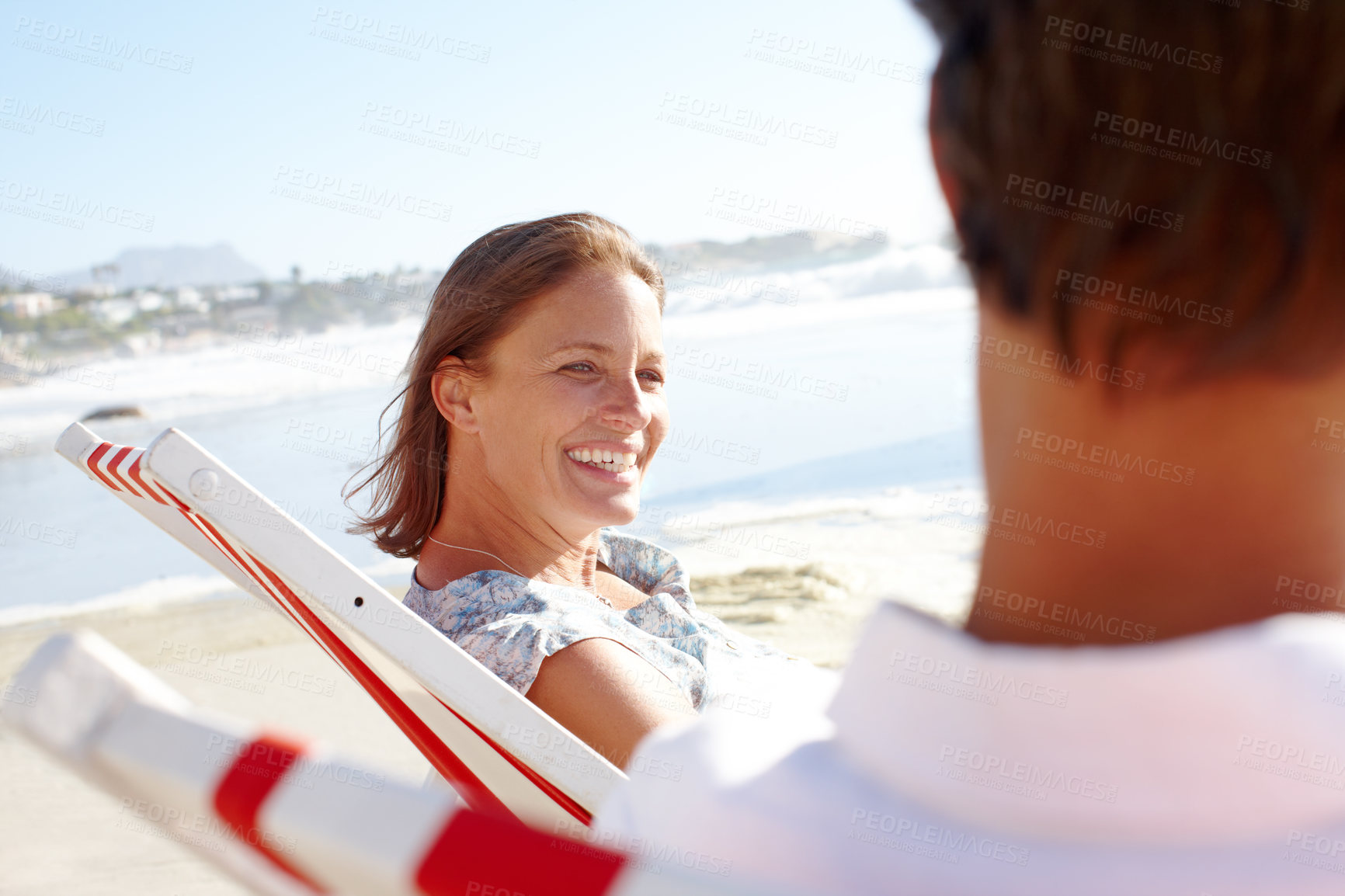 Buy stock photo Chair, happy woman or couple at sea to relax for love on vacation, anniversary or honeymoon holiday. Paradise, chill or people with smile at beach to relax together for travel, bonding or ocean trip