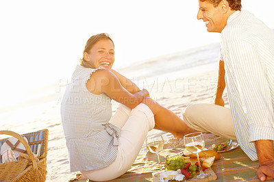 Buy stock photo Sunset, picnic portrait and couple with beach, wine and happy for summer vacation in Miami. Man, woman and smile with basket, sea holiday and bonding for relationship anniversary or weekend love