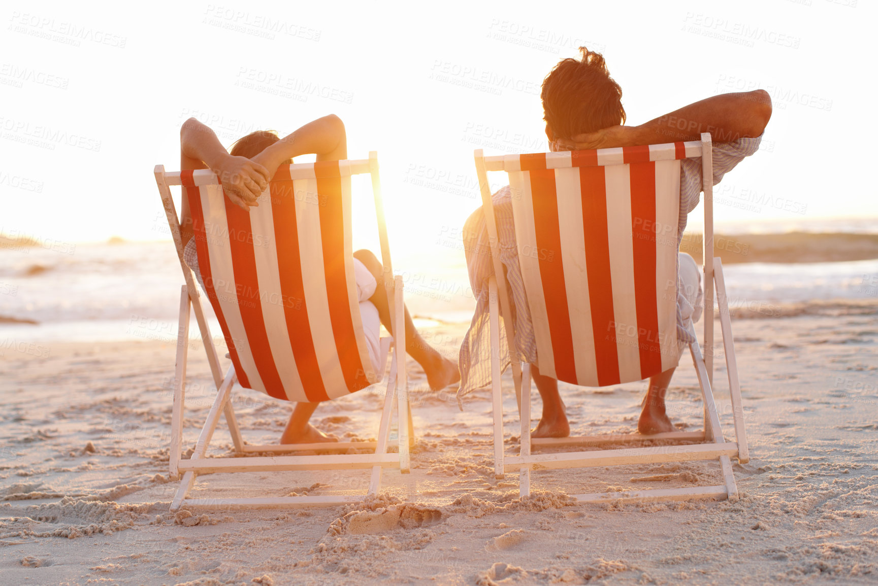 Buy stock photo Couple, back and relax on beach for sunset, bonding and tropical holiday on anniversary date with sunshine. Man, woman and romance by ocean for travel, love and vacation trip with chair in Maldives