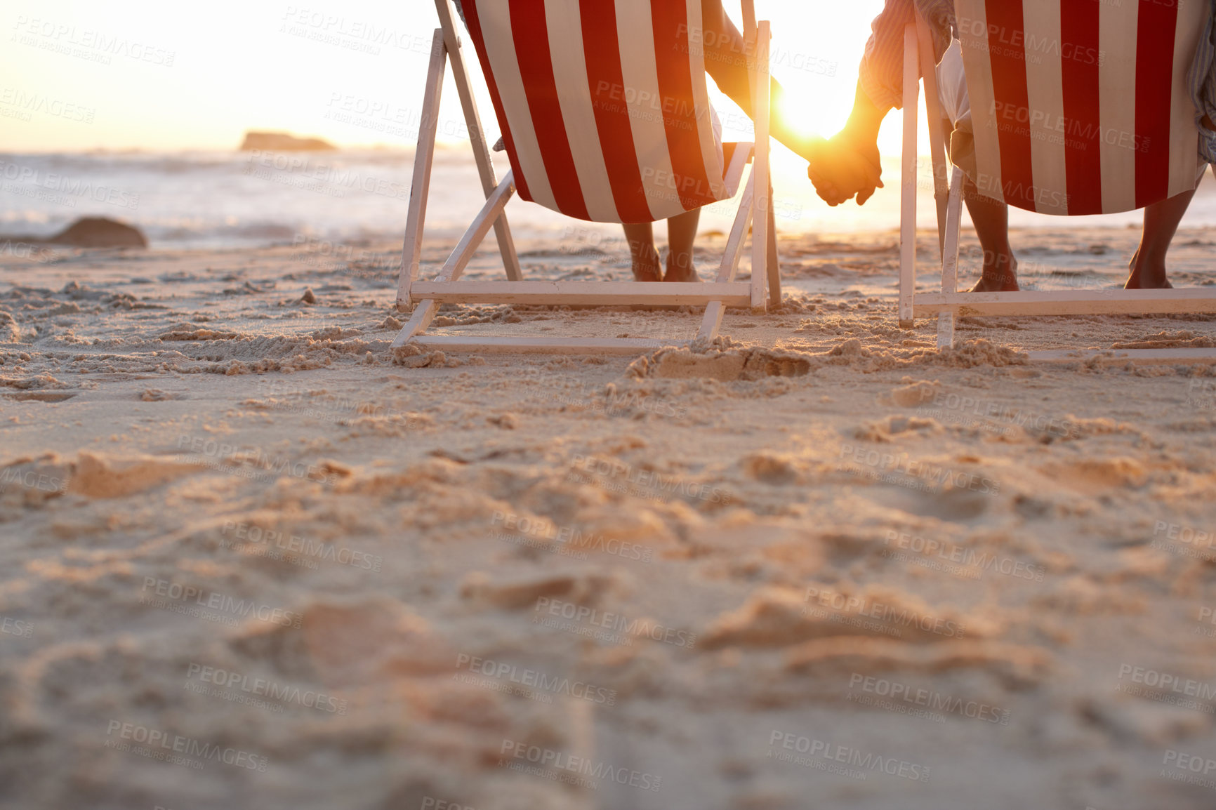 Buy stock photo Couple, back and holding hands on beach for travel, bonding and holiday on anniversary date with sunshine. Man, woman and relax by ocean for trip, love and tropical vacation with chair in Maldives